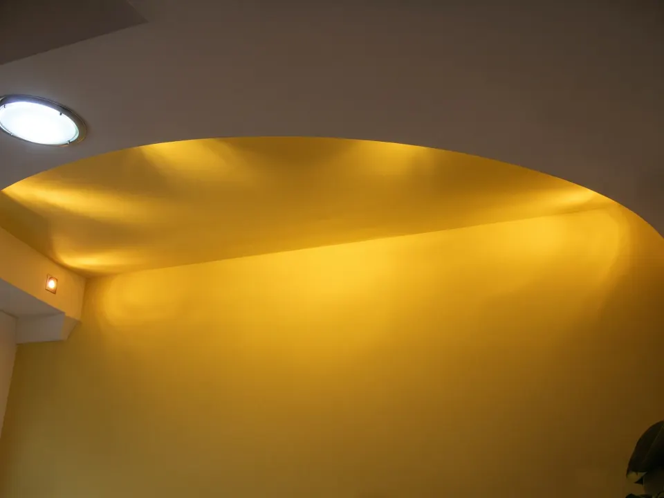 Curved golden ceiling with recessed spotlights